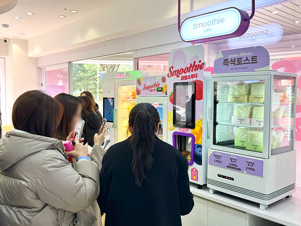 셀프 과일 스무디 기계를 이용하는 소비자들의 모습. BGF리테일 제공