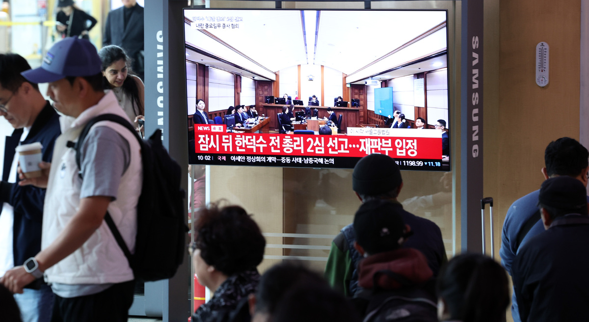 12·3 비상계엄 사태와 관련해 내란 중요임무 종사 등 혐의로 기소된 한덕수 전 국무총리의 2심 선고일인 7일 서울역 대합실에서 시민들이 선고 공판 방송을 지켜보고 있다. 뉴시스