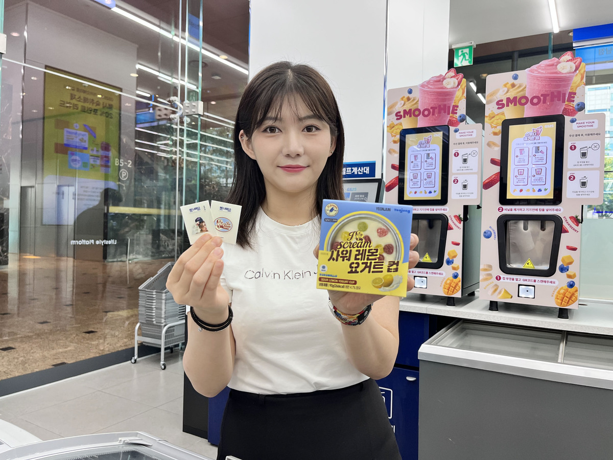GS25 모델이 TXT 연준 협업 상품인 사워레몬요거트&nbsp;아이스크림과 동봉된 스티커를 들고 포즈를 취하고 있다. GS리테일 제공